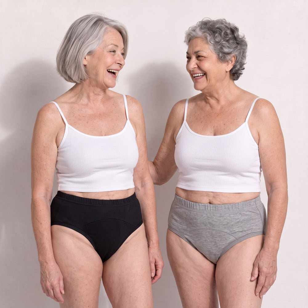 Deux femmes souriantes portent les culottes Urikare noire et grise.